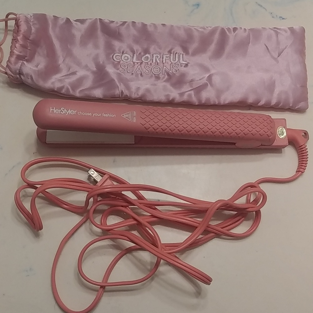 Pink HerStyler hair straightener.